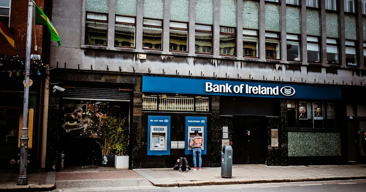 Person using an ATM at a bank building on a city street in Dublin