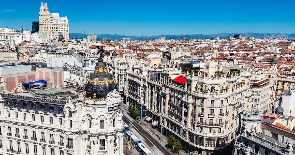 Tree-lined boulevard and historic buildings in central Madrid