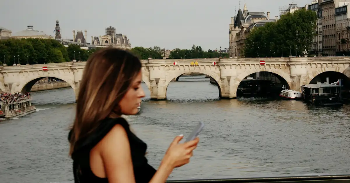 The Seine river in Paris, person using phone